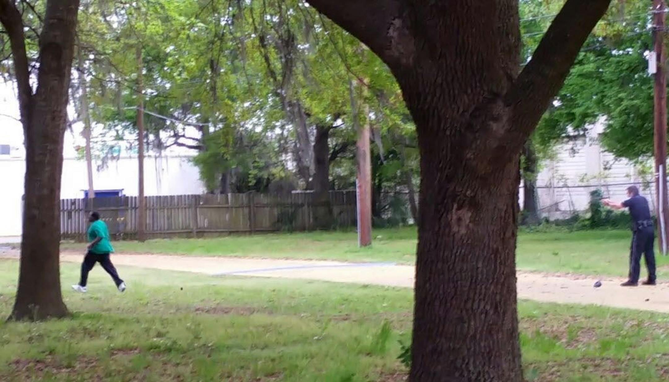 In this April 4, 2015, frame from video provided by Attorney L. Chris Stewart representing the family of Walter Lamer Scott, Scott appears to be running away from City Patrolman Michael Thomas Slager, right, in North Charleston, S.C.