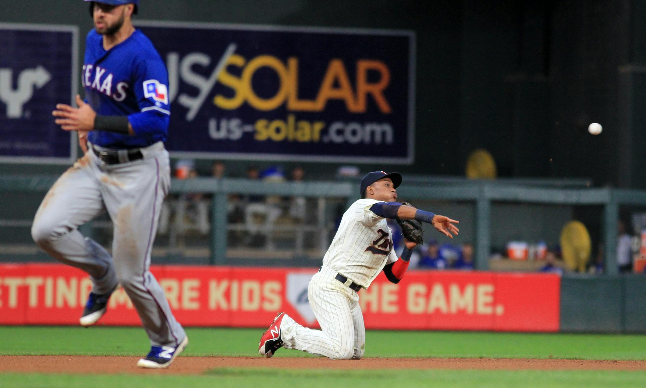 Minnesota Twins shortstop Jorge Polanco (11) throws from his knees, starting a double play, as Texas Rangers' Joey Gallo (13) runs during the fourth inning during a baseball game on Saturday, Aug. 5, 2017 in Minneapolis. The Rangers won 4-1. (AP Photo/Andy Clayton-King)