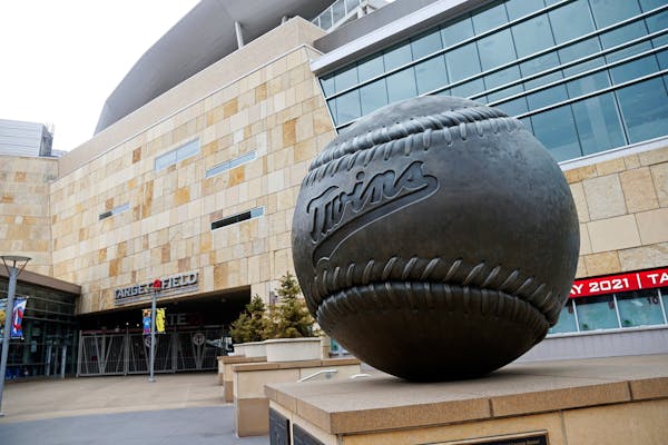 A giant baseball sculpture sits outside an empty Target Field, home of the Twins
