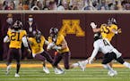 Gophers linebacker Josh Aune ran with the ball after an interception to seal Friday night's game vs. Purdue. One play earlier, the Boilermakers were f