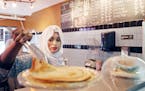 Bulbulo Mohamud lifted a piece of malawax (similar to a pancake) for a customer at her cafe.