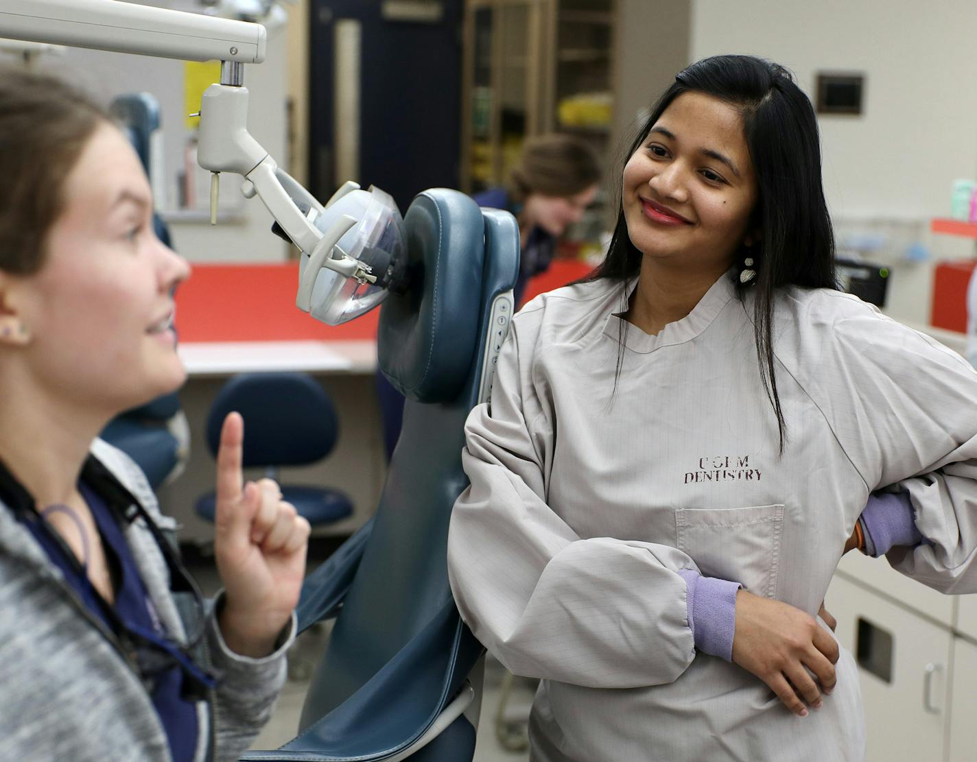 U dentistry students Neeharika Bhashyam, right, and Dasha Grishina, talked after class. Bhashyam has a spouse work permit.