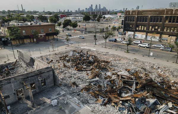 Buildings that were burned during unrest in late May remain a pile of rubble at the intersection of 27th Avenue and Lake Street in south Minneapolis.
