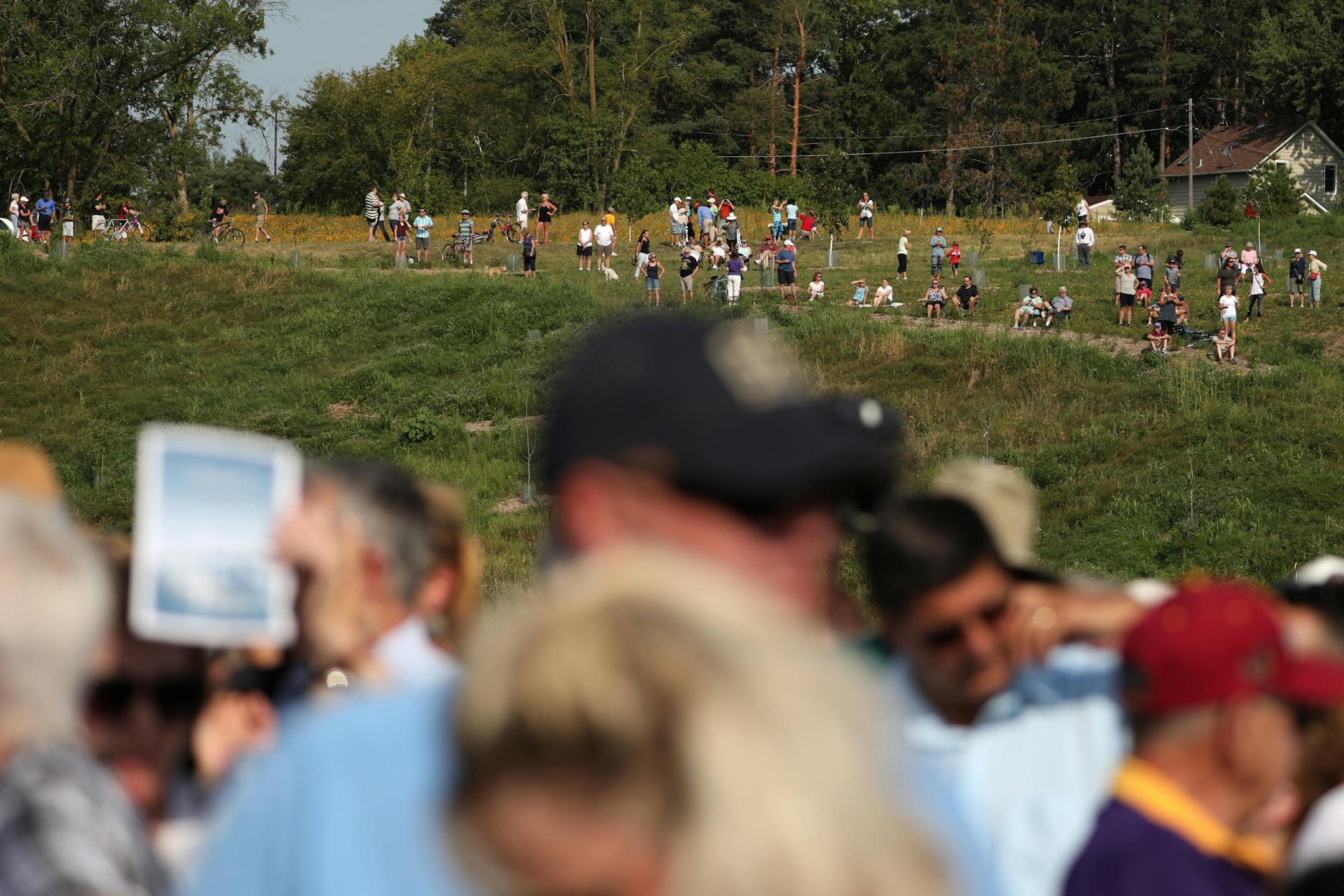 Community members watched the ribbon-cutting ceremony from an adjacent hill.
