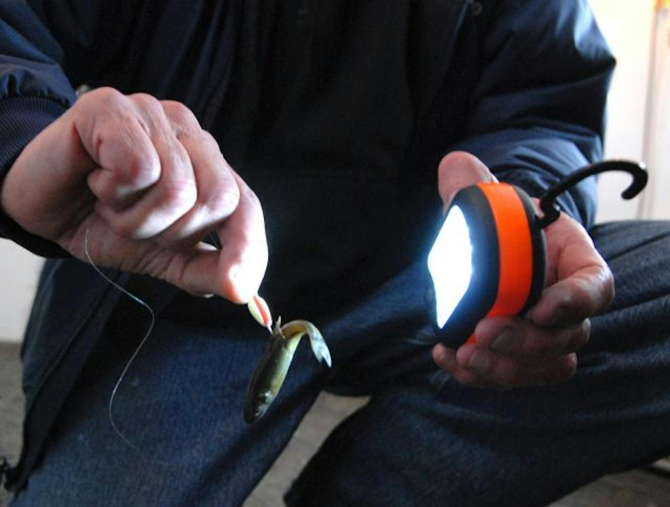 "Flashing'' photo-sensitive jigs to make them glow in the dark winter environs of Upper Red Lake can sometimes trigger walleyes to bite.