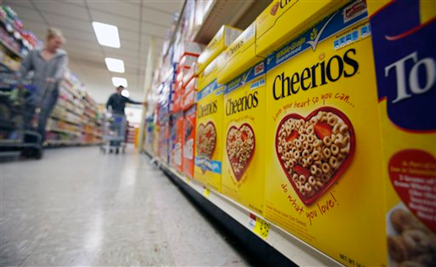 FILE - This June 16, 2011 file photo shows boxes of Cheerios in a store in Akron, N.Y. Large food companies are trying to head off state-by-state efforts to enact mandatory labeling of genetically modified ingredients by proposing new voluntary labels nationwide. The food industry and farm groups are pushing Congress to pass legislation that would require the Food and Drug Administration to create guidelines for the new labels, which food manufacturers could use. (AP Photo/David Duprey, File)