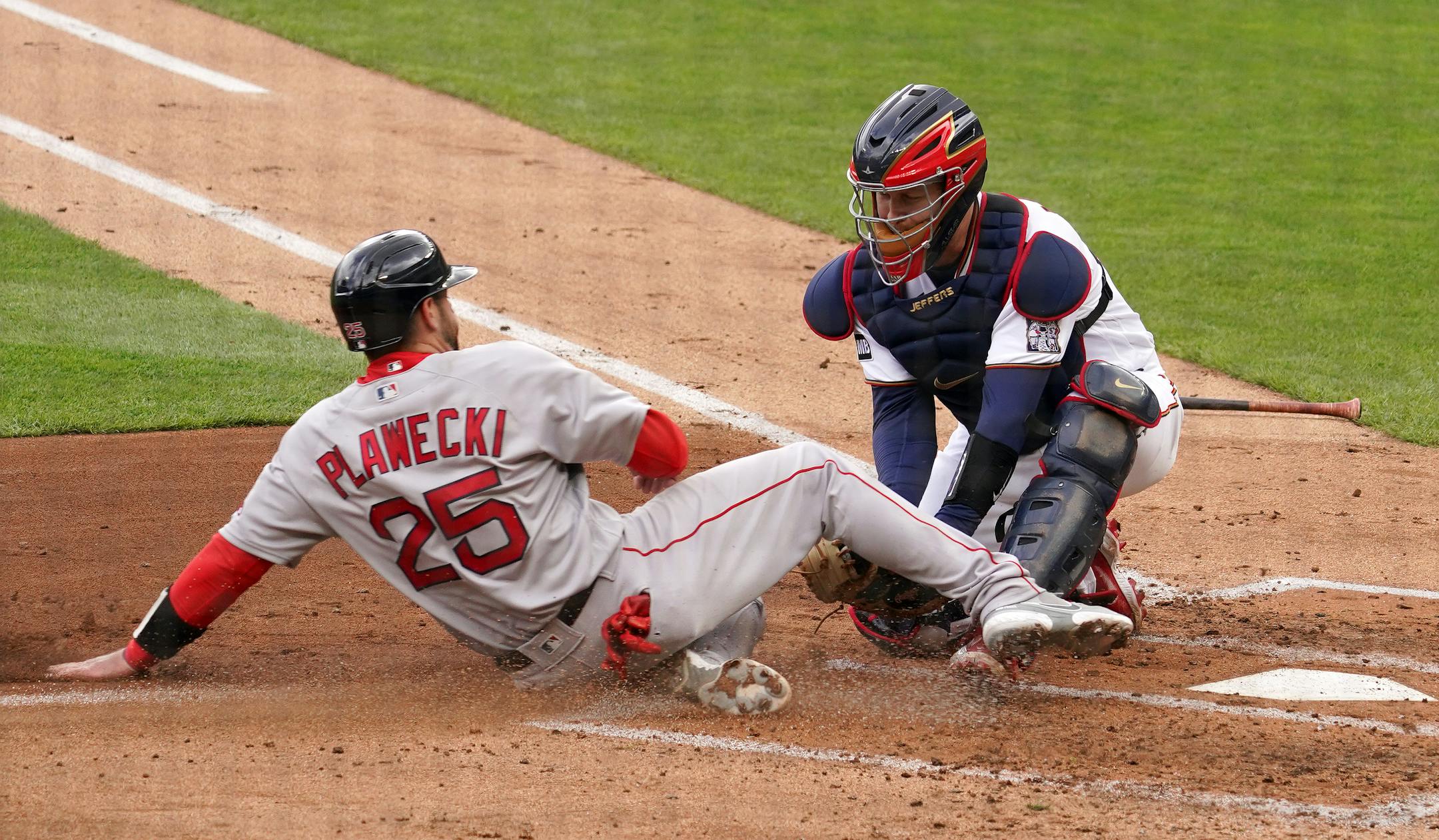 Minnesota Twins catcher Ryan Jeffers (27) tagged out Boston Red Sox catcher Kevin Plawecki (25) at home in the second inning.