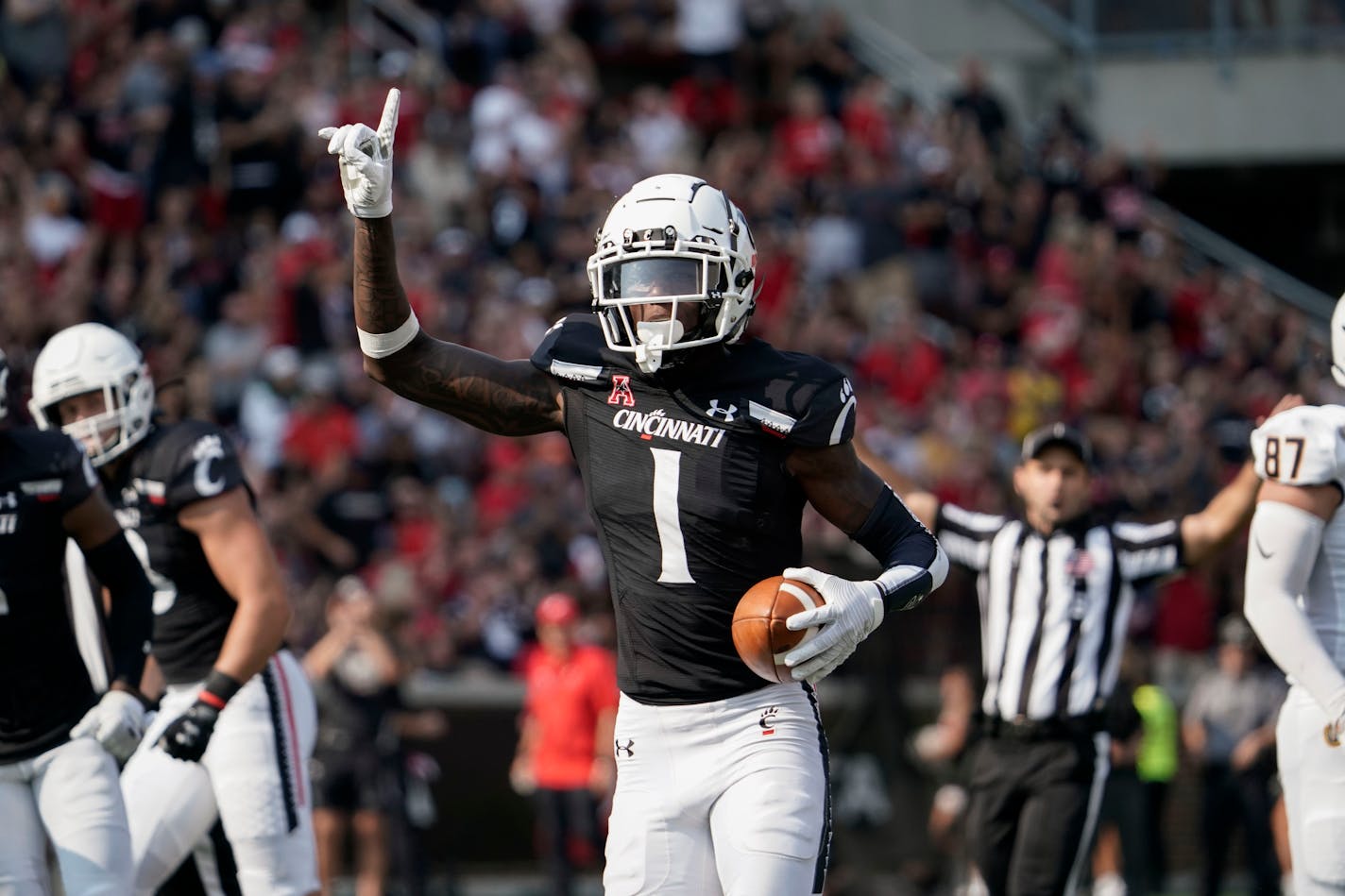 FILE - Cincinnati cornerback Ahmad Gardner (1) celebrates an interception of a Murray State pass during the first half of an NCAA college football game Sept. 11, 2021, in Cincinnati. Gardner, an Associated Press All-American who hasn't given up a touchdown in his college career, still has to declare for the draft. But he generally projects higher than any of his teammates, so that decision seems clear. (AP Photo/Jeff Dean, File)