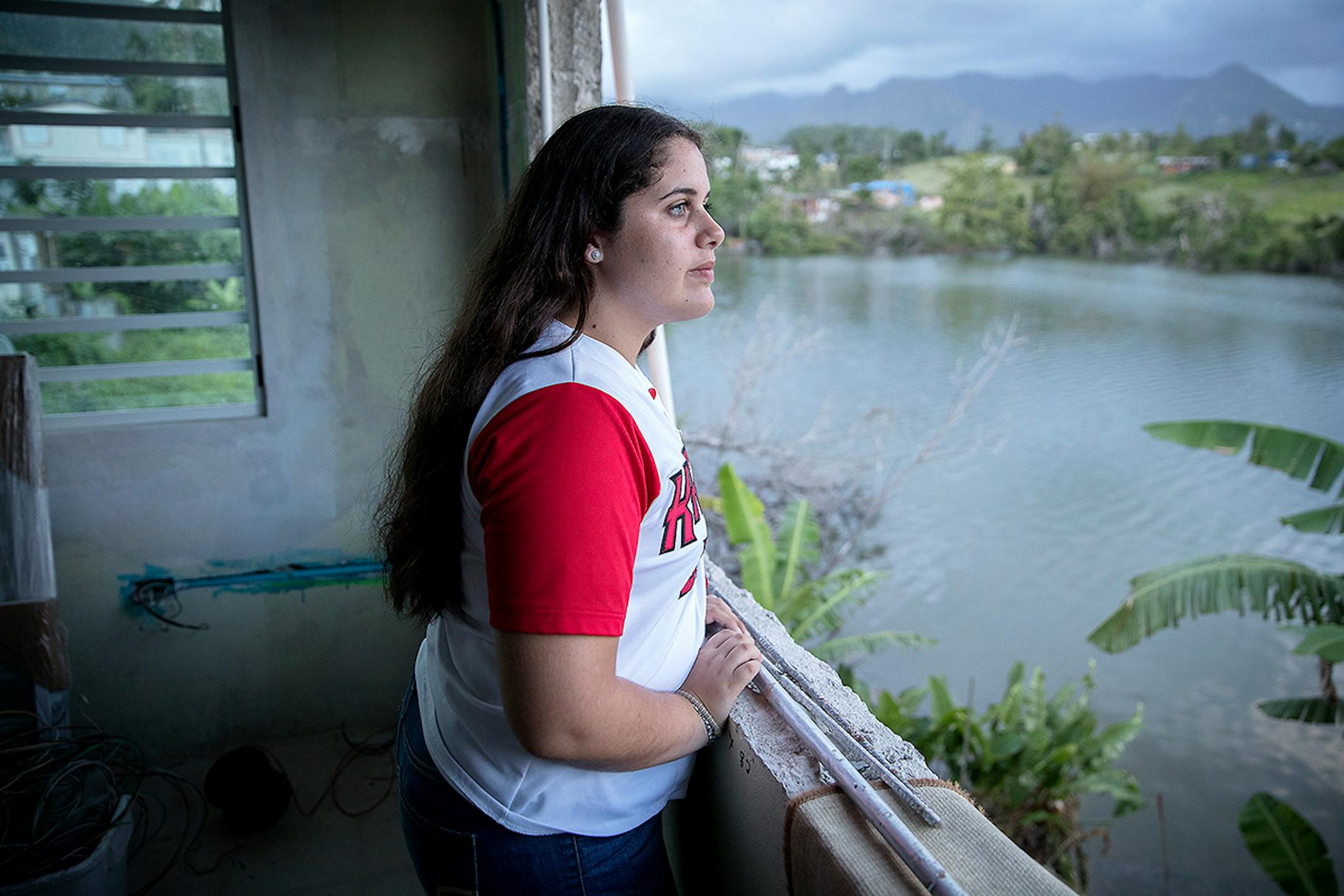 Liz Torres looked out a missing window at her home in Villalba, Puerto Rico. "I try not to think about it, but it's impossible because it was very traumatic."