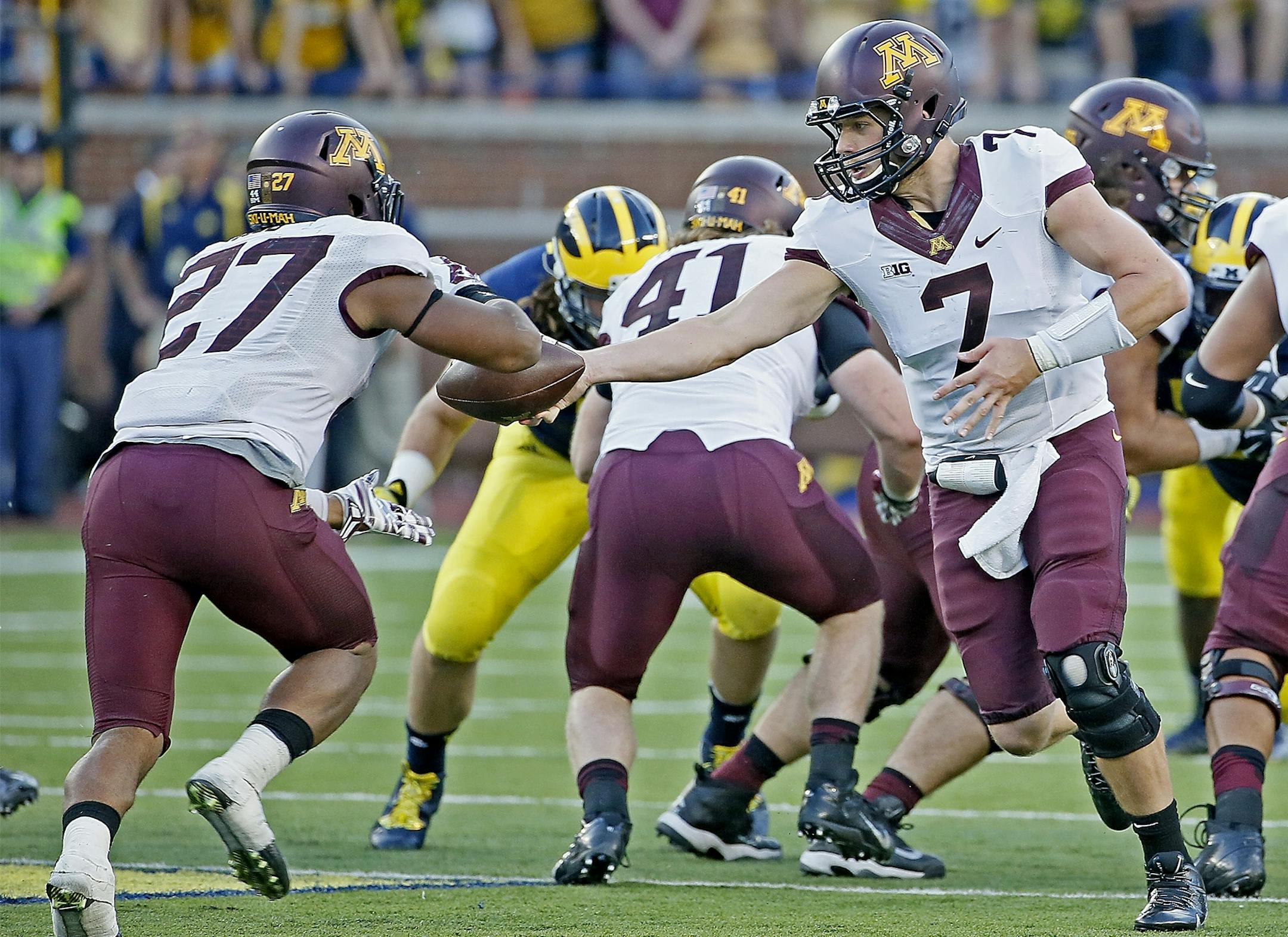 Minnesota quarterback Mitch Leidner (7) passed it off to Minnesota running back David Cobb (27) during the fourth quarter at Michigan Stadium, Saturday, September 27, 2014 in Ann Arbor, MI.