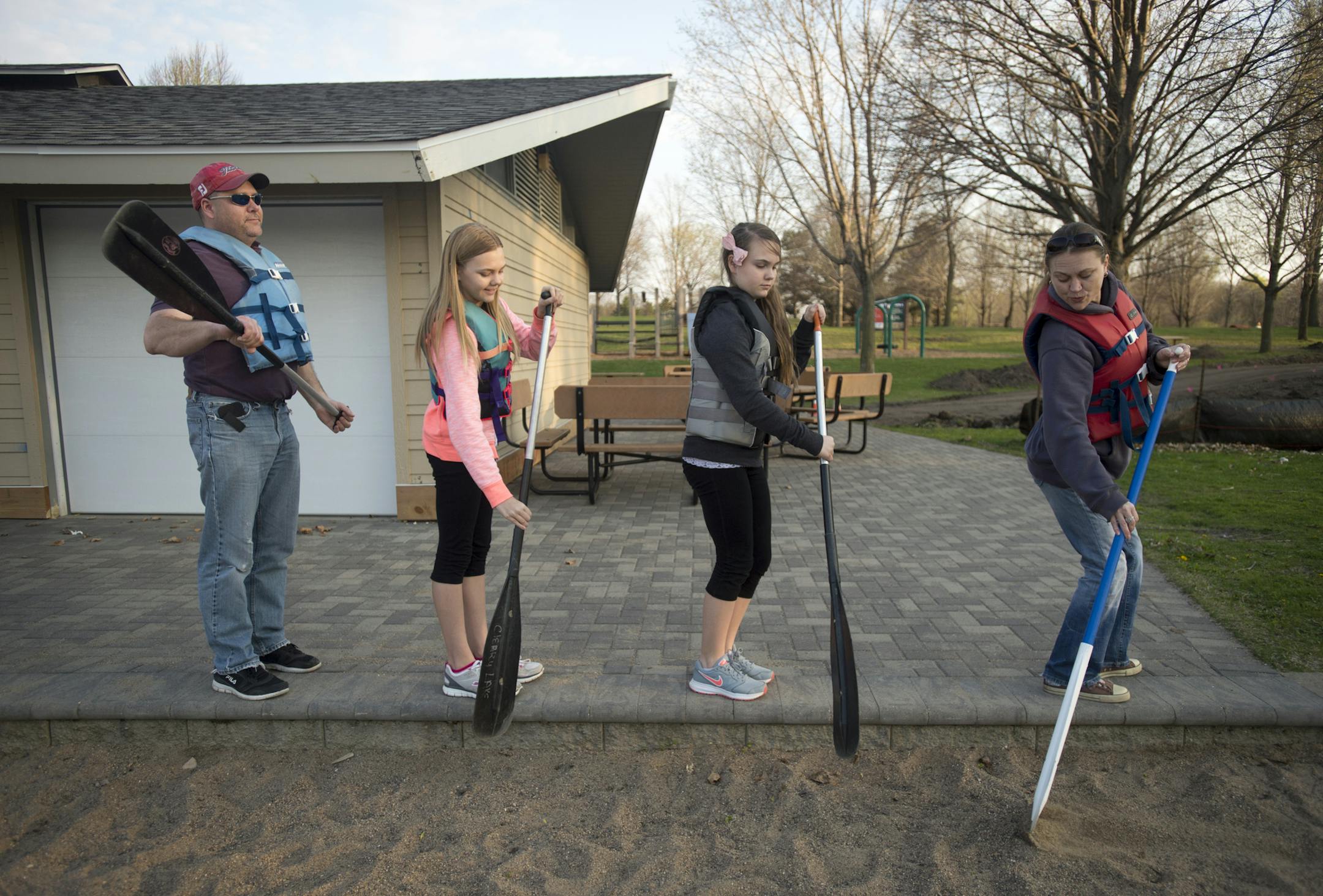 The Krocak family, including Ryan and his two daughters, Jessica, left, and and Samantha, and wife Ann, practice their paddle strokes before going out on a canoe excursion on Cleary Lake Friday night. ] (Aaron Lavinsky | StarTribune) aaron.lavinsky@startribune.com Three Rivers Parks District has figured out the full moon is a time of celebration. They offer some kind of night excursion for every full moon. This spring and summer it's canoeing. We photographed an hour-long canoe trip on Friday, M