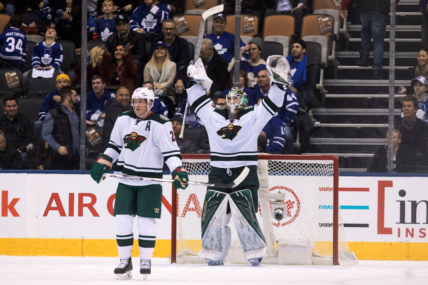 Minnesota Wild goalie Devan Dubnyk, center, celebrates as the clock counts down final seconds of the third period of an NHL hockey game in Toronto on Wednesday, Dec. 7, 2016. (Chris Young/The Canadian Press via AP)