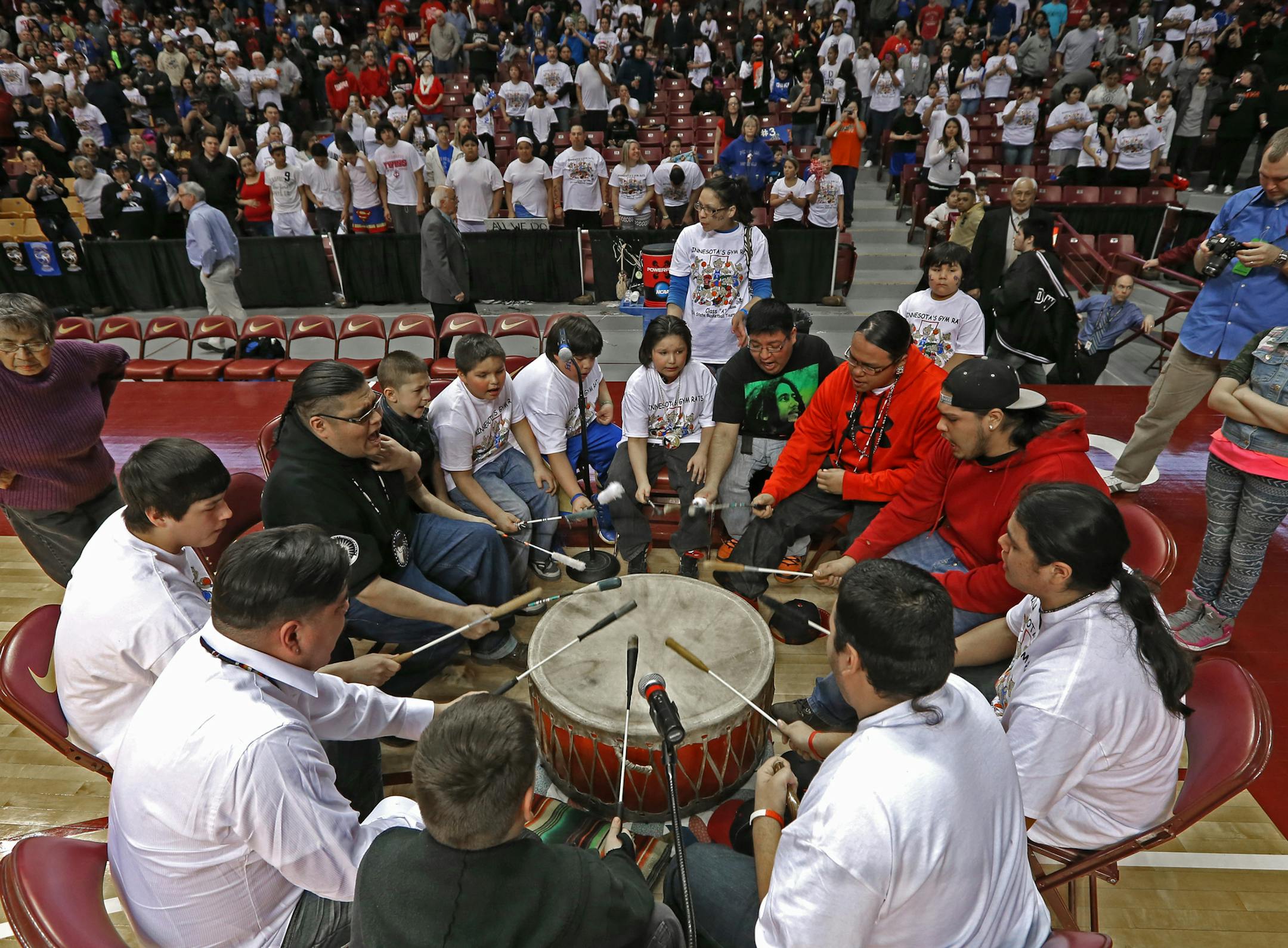 (left to right) Fond du Lac Ojibwe fans held a drum ceremony on court during halftime during the game against Canby.] Boys Basketball Tournament, Fond du Lac Ojibwe vs. Canby, Class 1A game at Williams Arena, 3/13/14. Bruce Bisping/Star Tribune bbisping@startribune.com