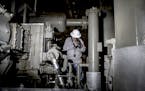 FILE -- A pipeline operator at Southwestern Energy uses an infrared camera to check for gas leaks, in Damascus, Ark., June 28, 2016. Some in the oil a