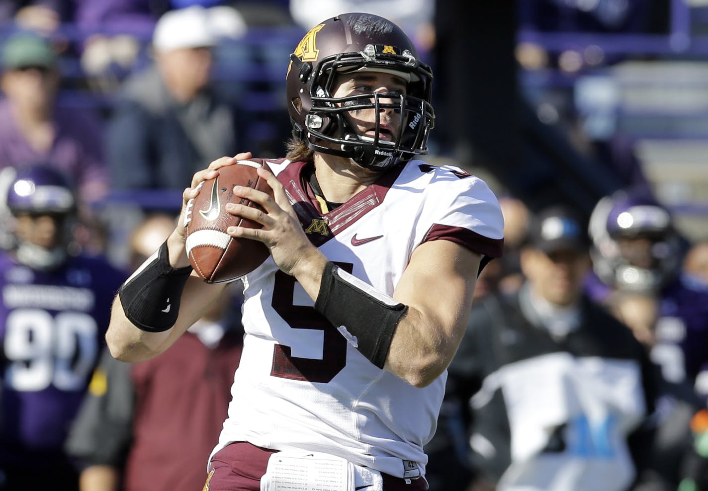 Minnesota quarterback Philip Nelson (9) looks to a throw during the first half of an NCAA college football game against Northwestern Saturday, Oct. 19, 2013, in Evanston, Ill. (AP Photo/Nam Y. Huh)