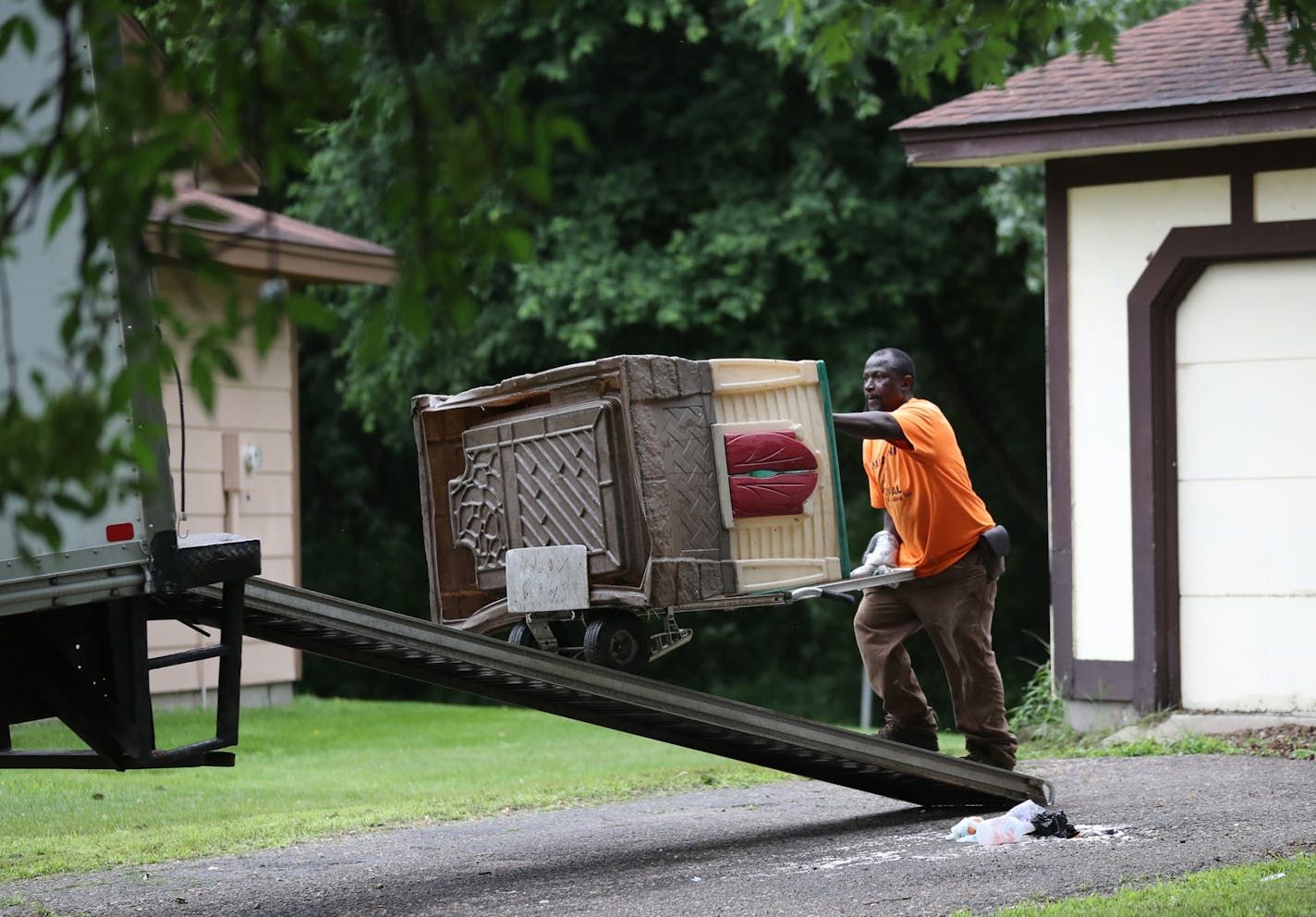 A missing 11-year-old Brooklyn Park girl was found safe Monday, but authorities removed three other children from the home, which they have deemed unfit. Here, a worker from Kaba Junk Removal, who declined to give his name, removes a toy house from the home Tuesday, June 19, 2018, in Brooklyn Park, MN.