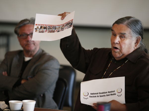 Clyde Bellecourt held up anti racism signs as members of the Native American community meet with the Minneapolis and University of Minnesota Police de