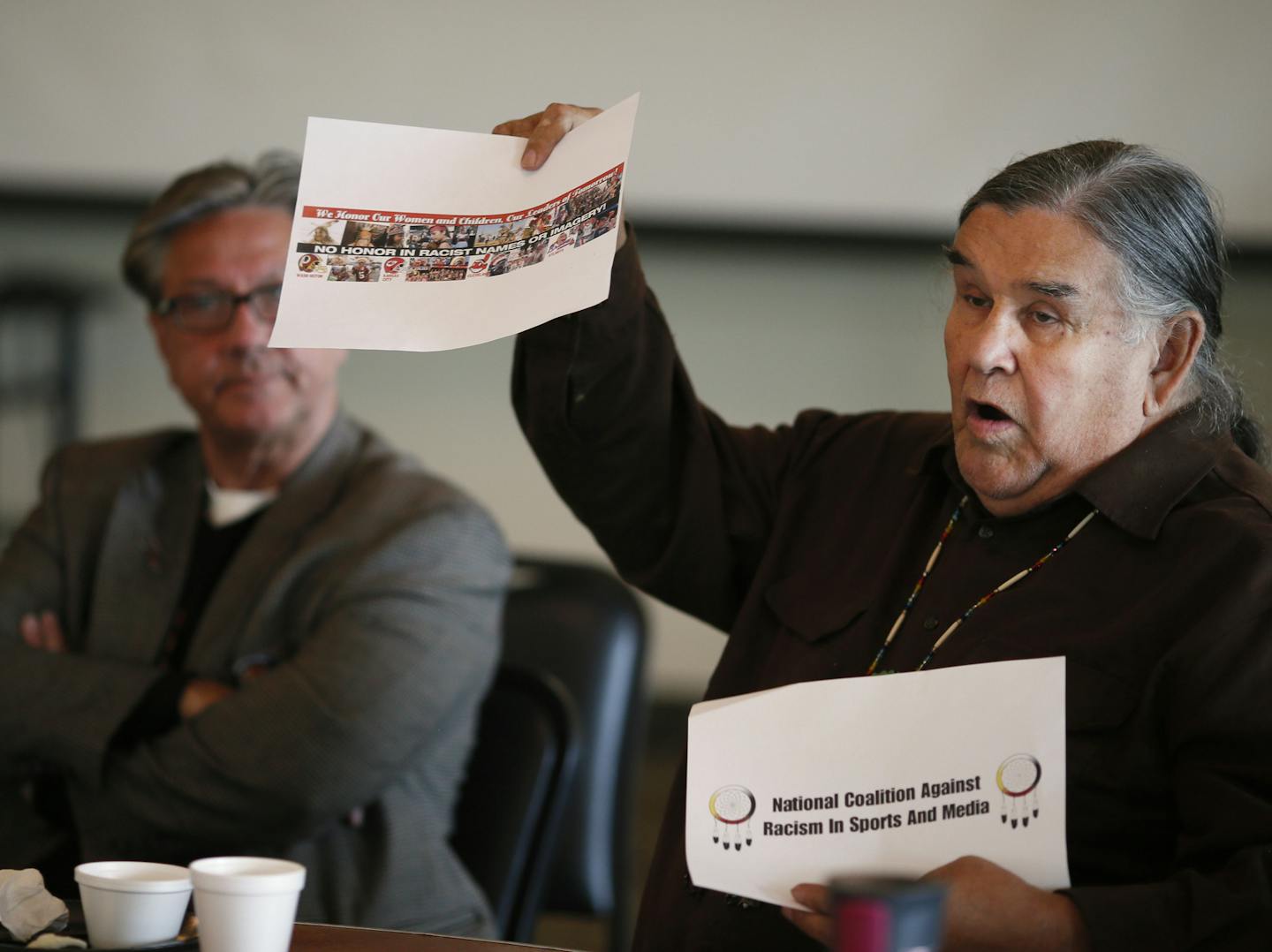 Clyde Bellecourt held up anti racism signs as members of the Native American community meet with the Minneapolis and University of Minnesota Police departments to discuss the protest against the Washington Redskins at the Black Bear Crossing Wednesday October 29 , 2014 in St. Paul,MN. The Vikings are hosting the Washington Redskins on Sunday at TCF stadium, and a large protest will be held to protest the Redskins nick name. ] Jerry Holt Jerry.holt@startribune.com