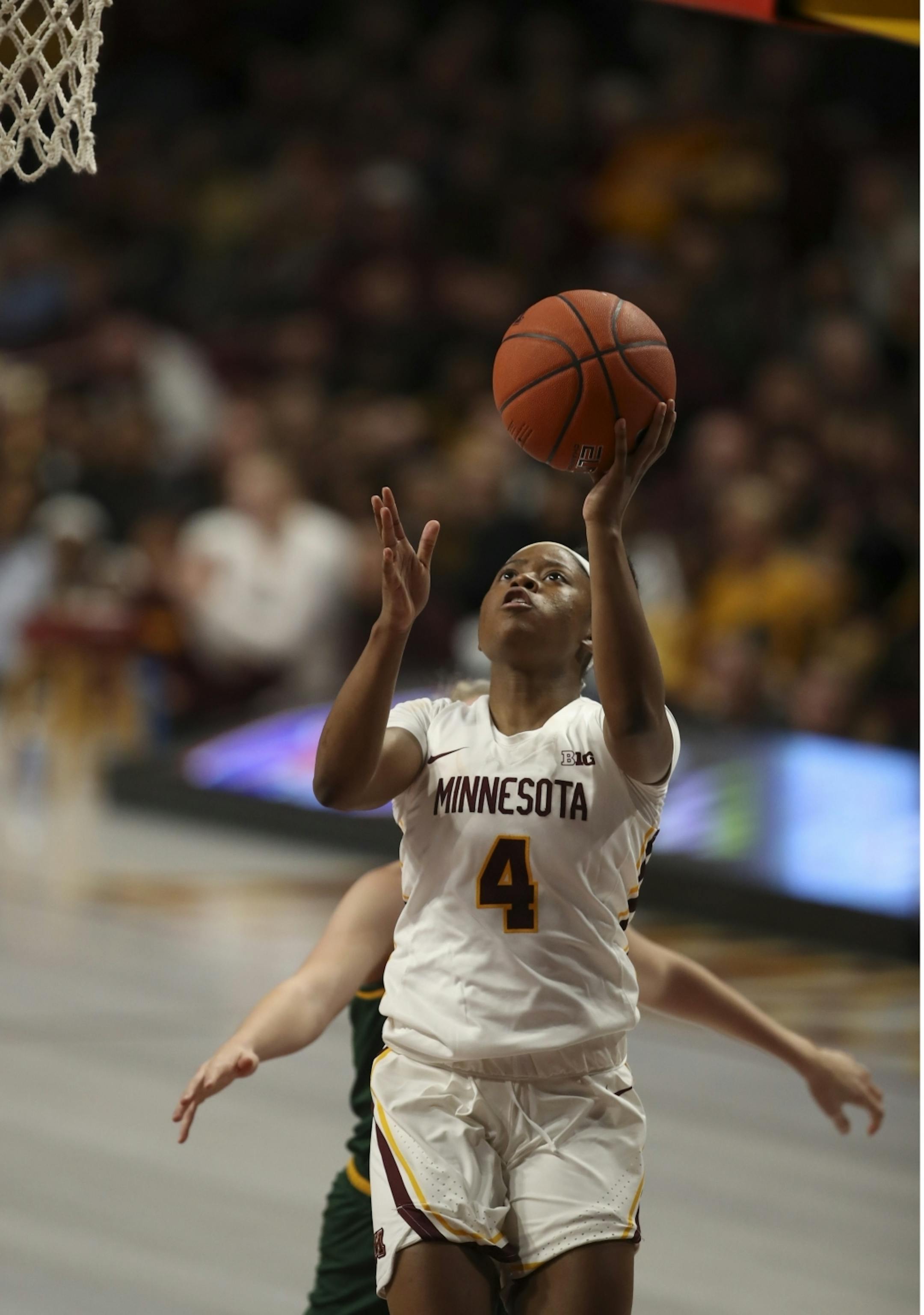 Minnesota Golden Gophers guard Jasmine Powell (4) put up two of her 19 points while trailed by Vermont Catamounts forward Delaney Richason (33) in the second quarter.