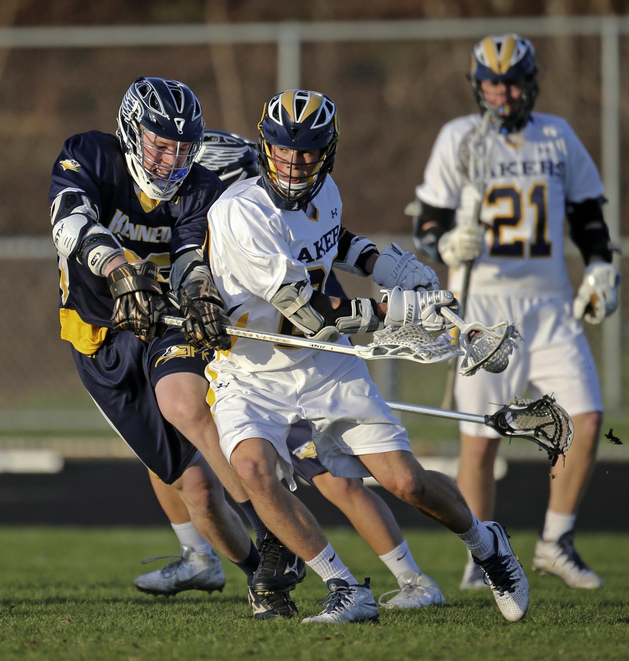 Prior Lake's midfielder Cullen Sowder, center, moves the ball upfield during their lacrosse game versus Bloomington Kennedy at Prior Lake High Friday, May 9, 2014.](DAVID JOLES/STARTRIBUNE) djoles@startribune Prior Lake's boys' lacrosse team versus Bloomington Kennedy at Prior Lake High Friday, May 9, 2014.**Cullen Sowder,cq