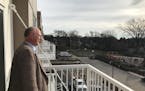 Chris Wilson, the senior director of real estate development at Project for Pride in Living, looks out from the balcony of Oxford Village, a new 51-un