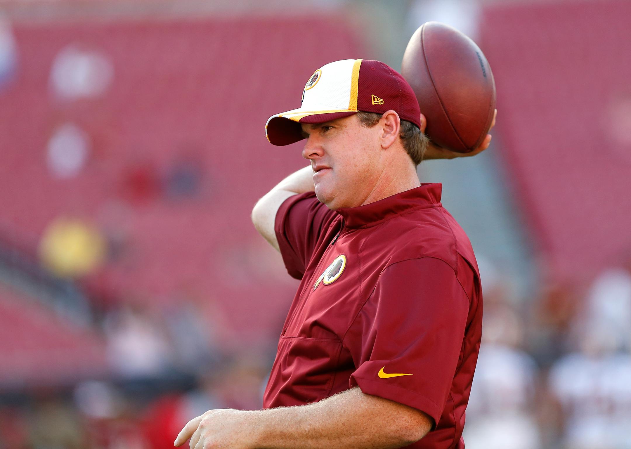Washington Redskins head coach Jay Gruden tosses the football before the start of a preseason NFL football game against the Tampa Bay Buccaneers Thursday, Aug. 28, 2014, in Tampa, Fla. (AP Photo/Brian Blanco)