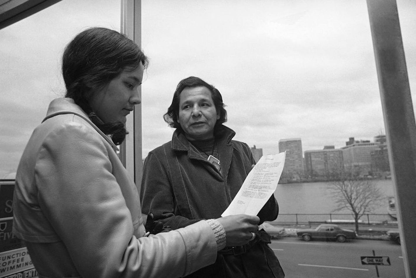 FILE - in this Nov. 4, 1971 file photo, Eddie Benton, a holy man of the Chippewa Indian Tribe, shows a prayer he wrote to Linda Jeffers, of Vineyard Haven, Martha's Vineyard, Mass., a member of the Wampanoag Tribe in Cambridge, Mass. Eddie Benton-Banai, one of the founders of the American Indian Movement that was formed partly in response to alleged police brutality against Indigenous people, has died. He was 89. A family friend says Benton-Banai died Monday, Nov. 30, 2020 at a care center in Ha