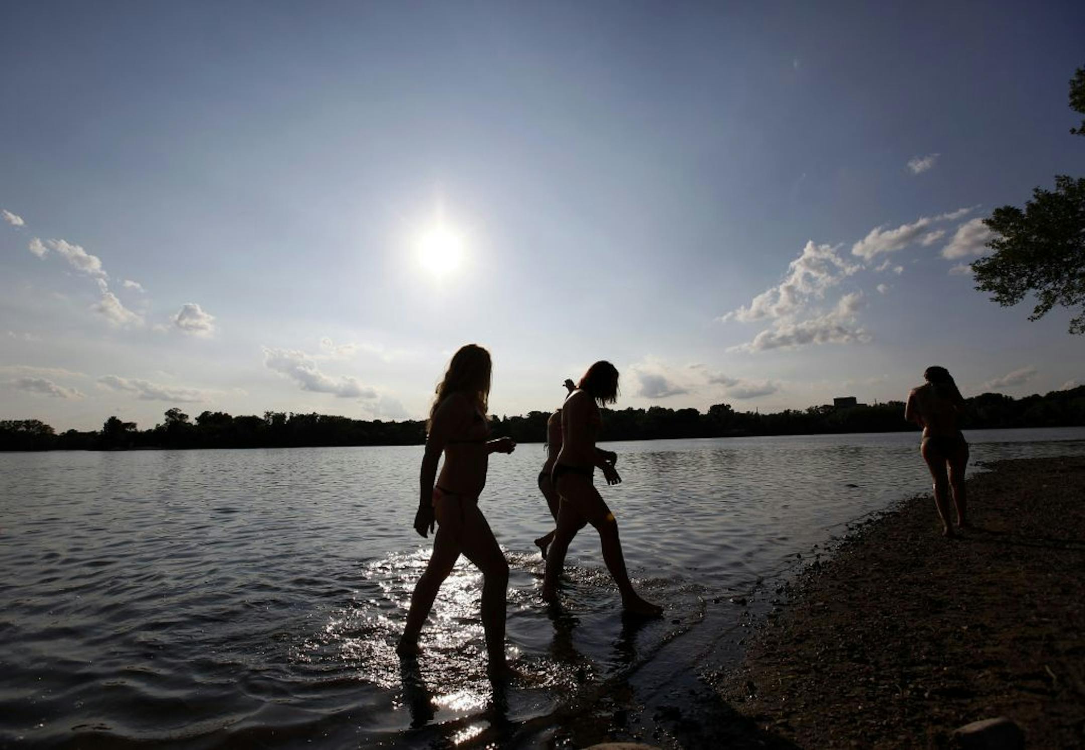 Swimmers getting out of the water at East Cedar Lake beach. Cedar Lake, Minneapolis, MN.