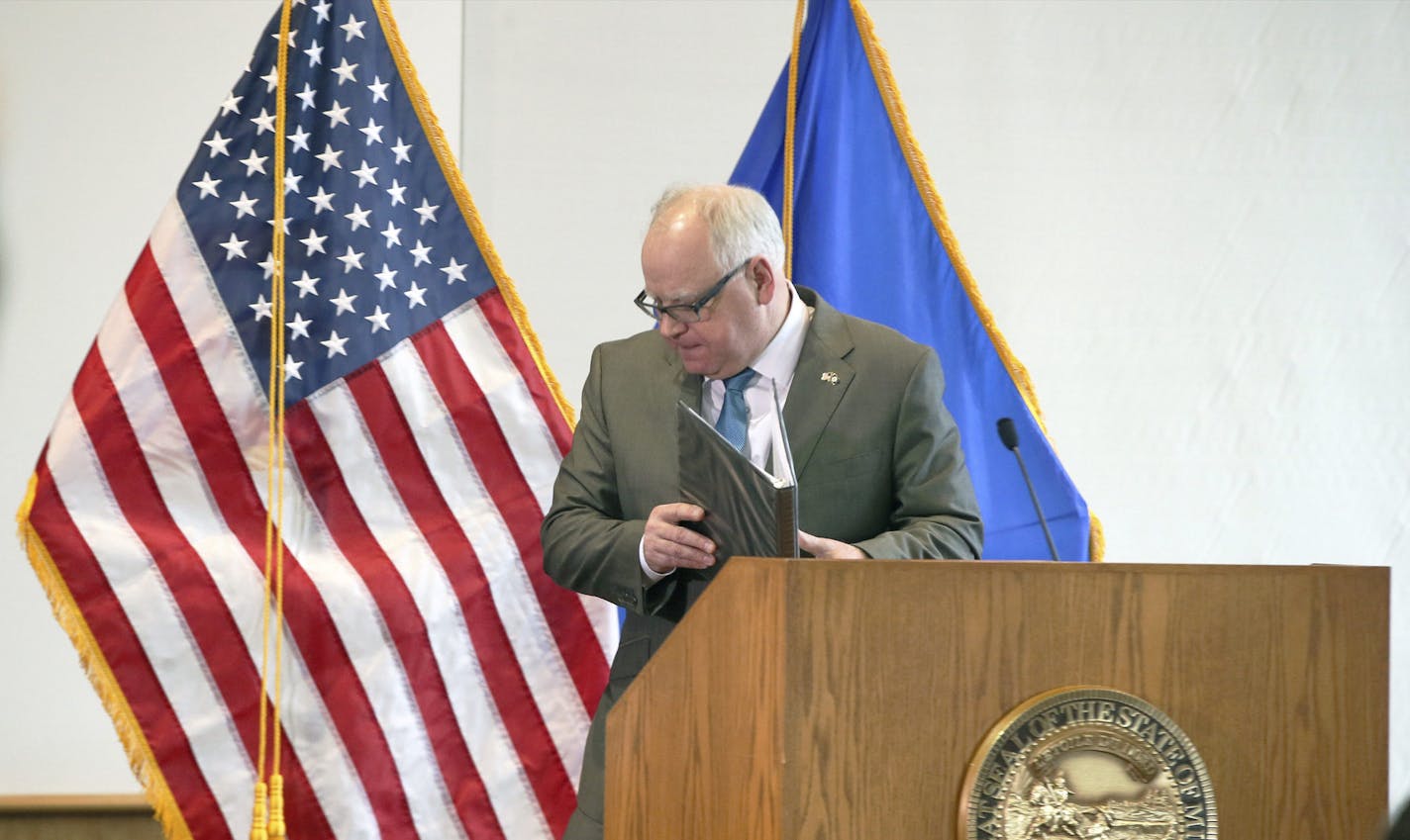 Minnesota Gov. Tim Walz, shown finishing a press conference on coronavirus last week, and other top political leaders are confronting fundamental ethical questions and tradeoffs with enormous stakes.