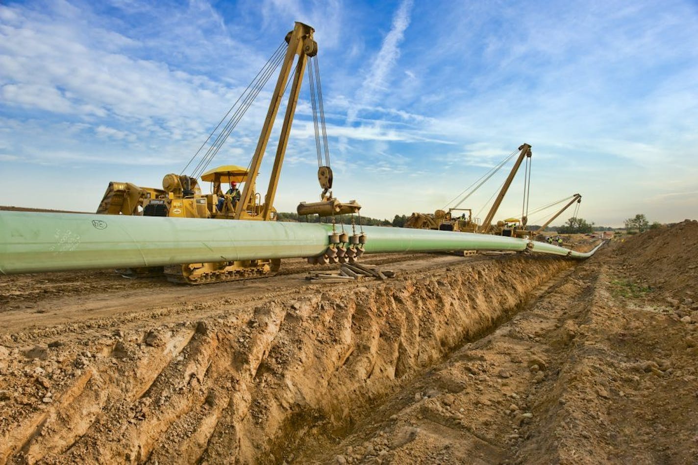 FILE -- A crew installs a section of a crude oil pipeline for Enbridge Energy. The Calgary-based pipeline company wants to build a new 337-mile pipeline across northern Minnesota to replace its aging "Line 3."