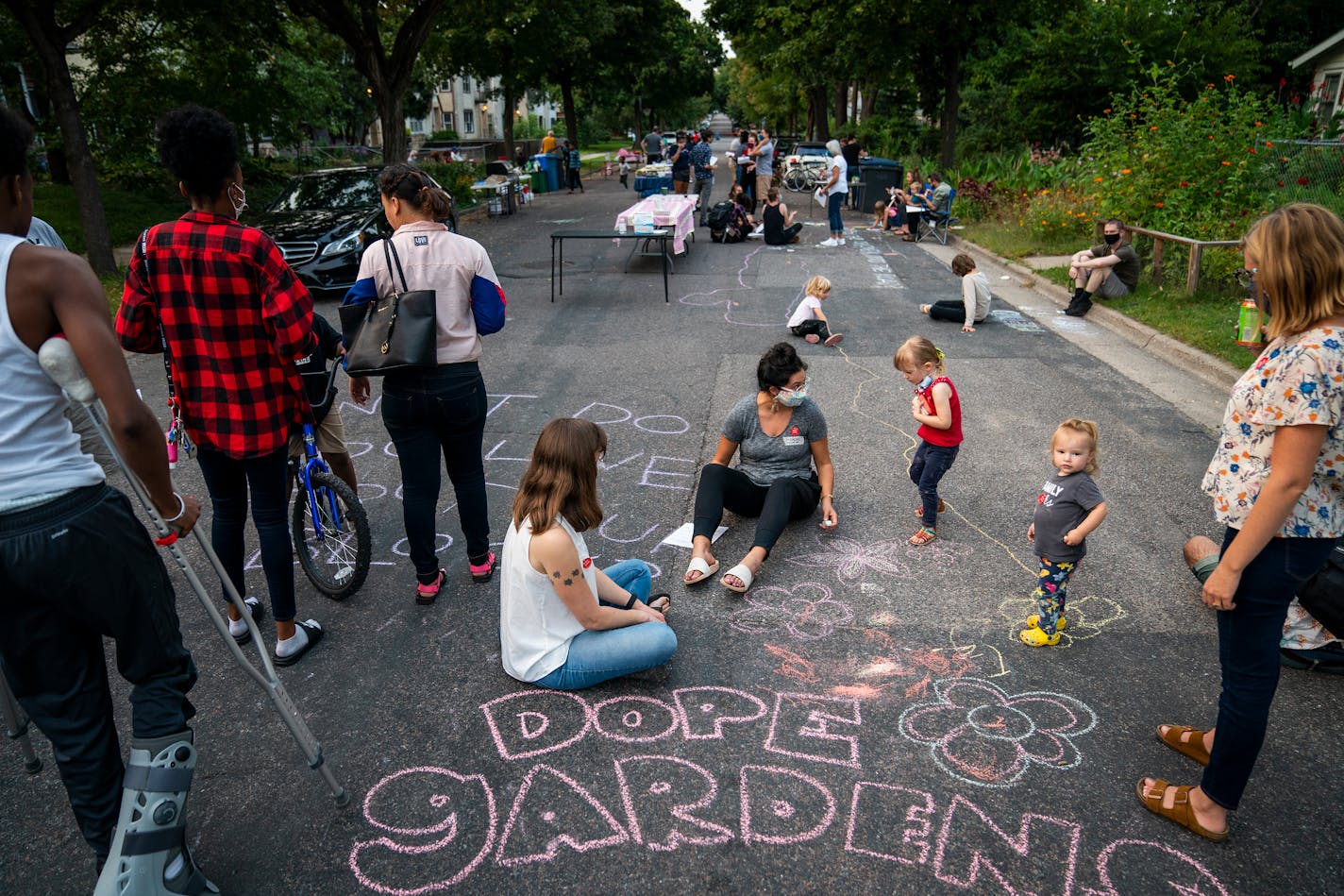 Families gathered Tuesday and decorated the street with chalk art, including writing what they love about their block, during National Night Out on S. 10th Avenue South between 37th and 38th streets in Minneapolis.