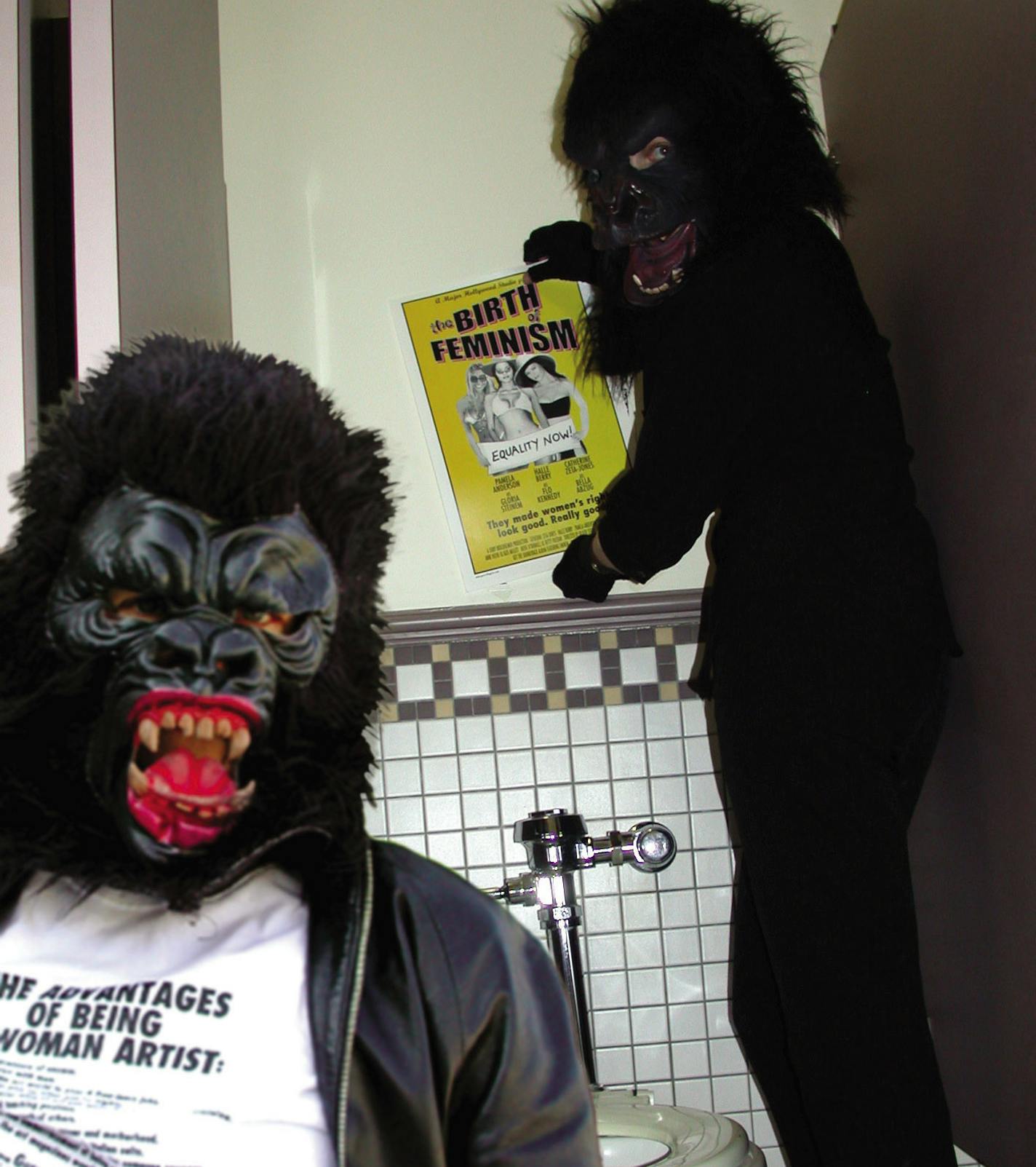 Here is the image of Guerrilla Girls Frida Kahlo and Kathe Kollwitz stickering a movie theater bathroom in Hollywood.