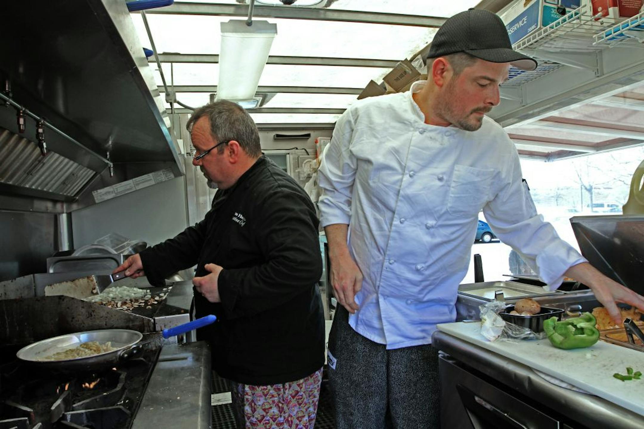 Chefs Kevin Huyck and Jon Seeman prepared mac and cheese along with other lunch items while serving from R.A. MacSammy's lunch truck. The truck was serving lunch while parked at 1450 Energy Park Drive in St. Paul.