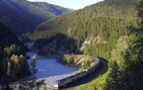 FILE - In this June 26, 2011 file photo, Amtrak's Empire Builder makes its way along the southern boundary of Glacier National Park near West Glacier,