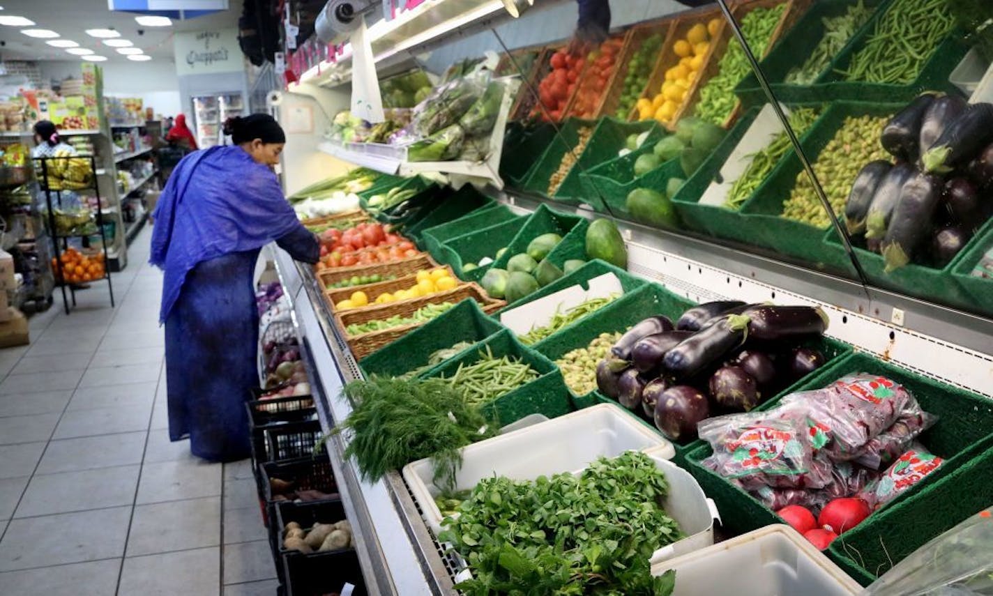 Little India International Market is one of the stores participating in the city's staple food ordinance. Here, store customer Maimuna, shops for tomatoes (that is the only name the woman could come up with) Friday, May 6, 2016, in northeast Minneapolis, MN.