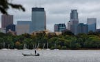 A fall approaches, a fisherman tried his luck in the chilly waters of Lake Calhoun, in the shadow of the downtown Minneapolis skyline. ] JIM GEHRZ&#x2