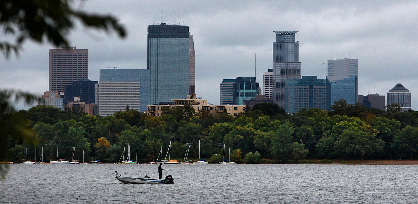 A fall approaches, a fisherman tried his luck in the chilly waters of Lake Calhoun, in the shadow of the downtown Minneapolis skyline. ] JIM GEHRZ&#x201a;&#xc4;&#xa2;jgehrz@startribune.com (JIM GEHRZ/STAR TRIBUNE) / September 21, 2011/1:00 PM ,Minneapolis MN**