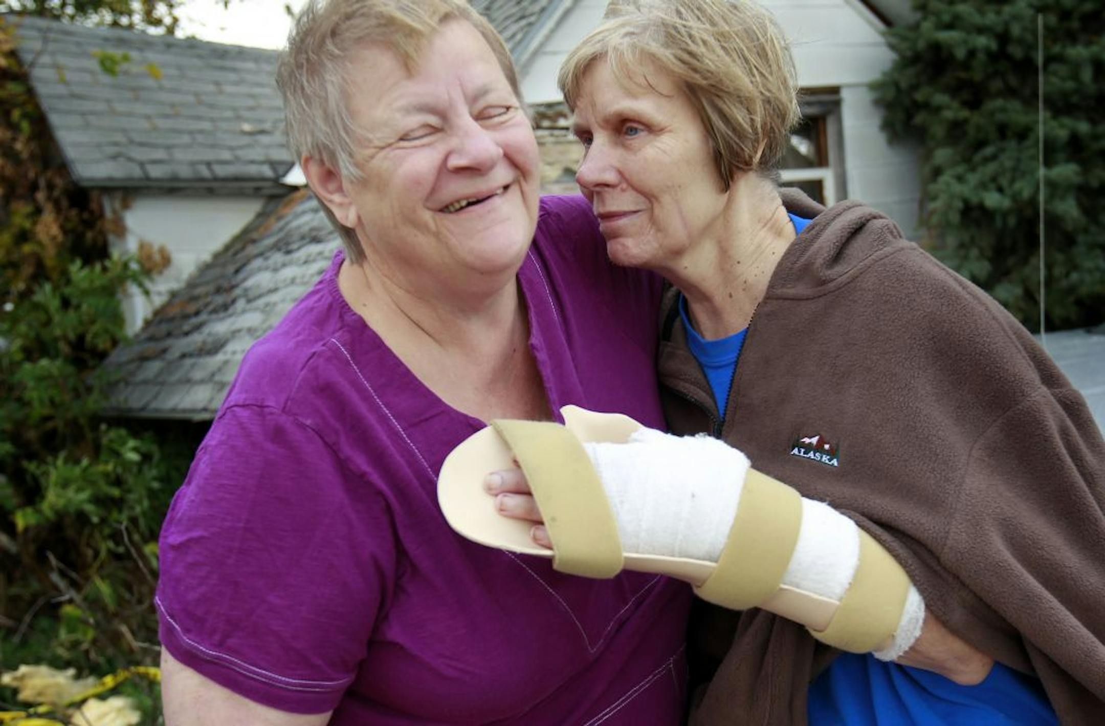 Janice Harms (right) got a hug from Anita Grossman in front what was left of Harms' Clara City home on Monday.