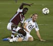 Colorado Rapids forward Dominique Badji, left, and Minnesota United defender Brent Kallman go after the ball during the first half of an MLS soccer ma