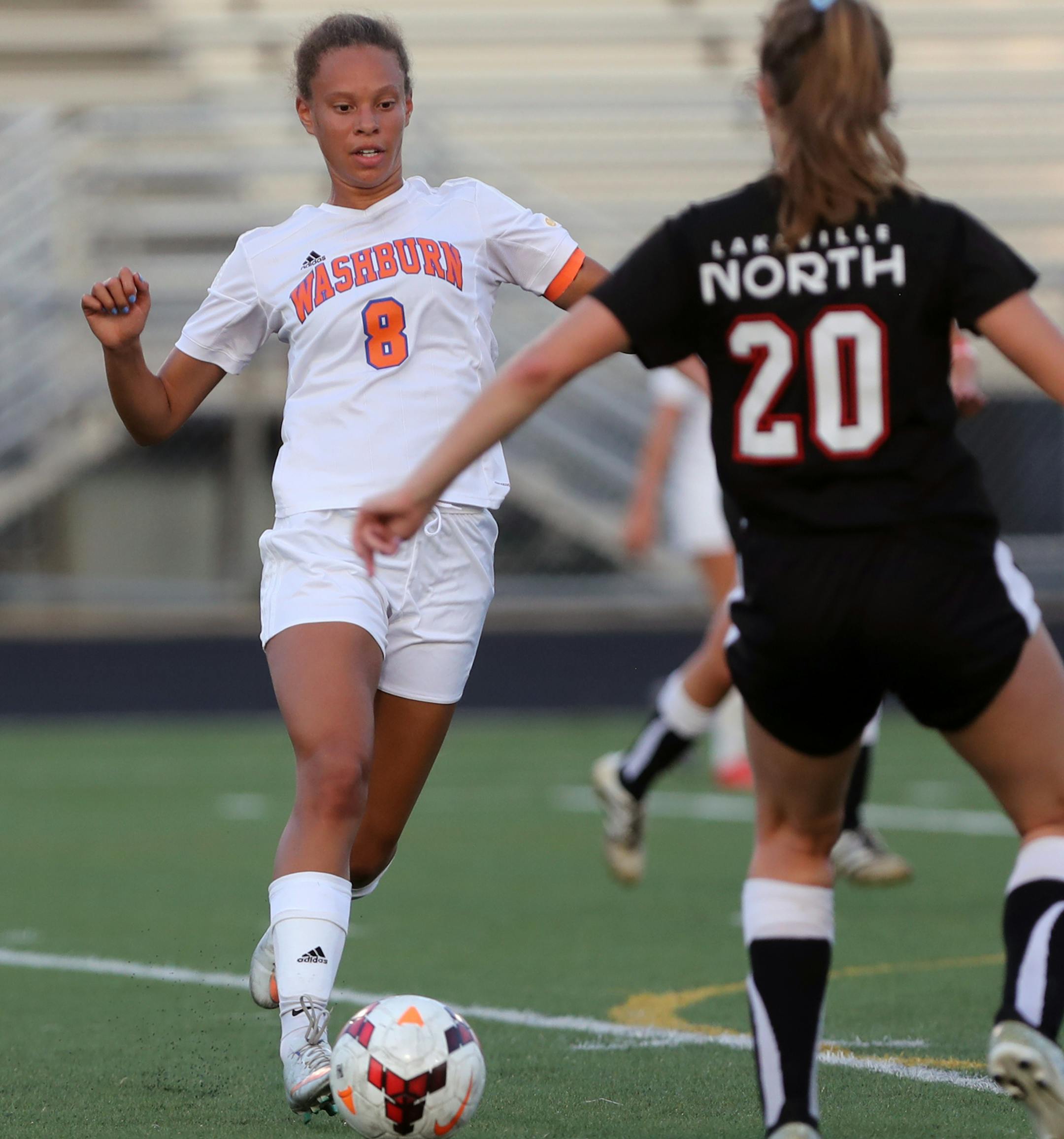 Minneapolis Washburn's Charlotte DeVaughn (8) tried to dribble past Lakeville North's Analiese Tschida.