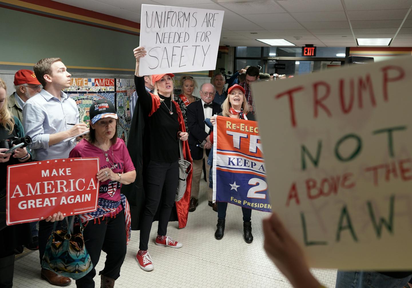 A group of about 30 pro Trump supporters gathered for a rallying at noon Wednesday outside Mayor Jacob Frey's office in City Hall, to show "how displeased they are with his behavior over the Trump visit. Here, Mary Susan Timion (center), cloaked in a light up Trump cape, spoke out against Mayor Frey's recent efforts to bill the Trump campaign for security costs for his Thursday rally, and also voiced support the police officers desire to wear their MPD uniforms to the rally. At right, a lone Fre