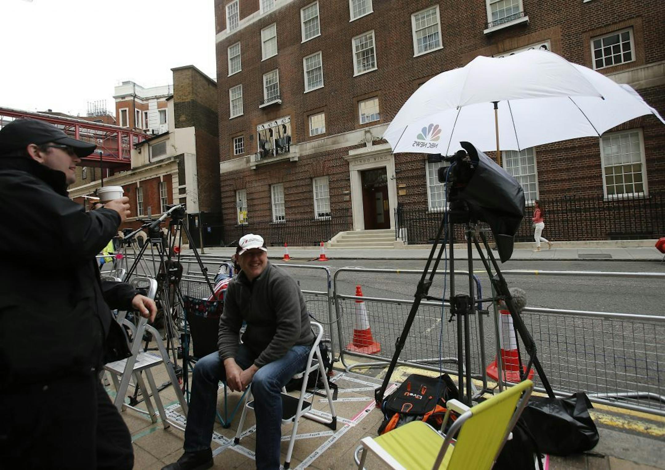 Journalists prepare at the entrance to the Lindo Wing at St Mary's Hospital in London, Tuesday, July 2, 2013. Media are preparing for royal-mania as Britain's Duchess of Cambridge plans to give birth to the new third-in-line to the throne in mid-July, at the Lindo Wing. Cameras from all over the world are set to be jostling outside for an exclusive first glimpse of Britain's Prince William and the Duchess of Cambridge's first child.