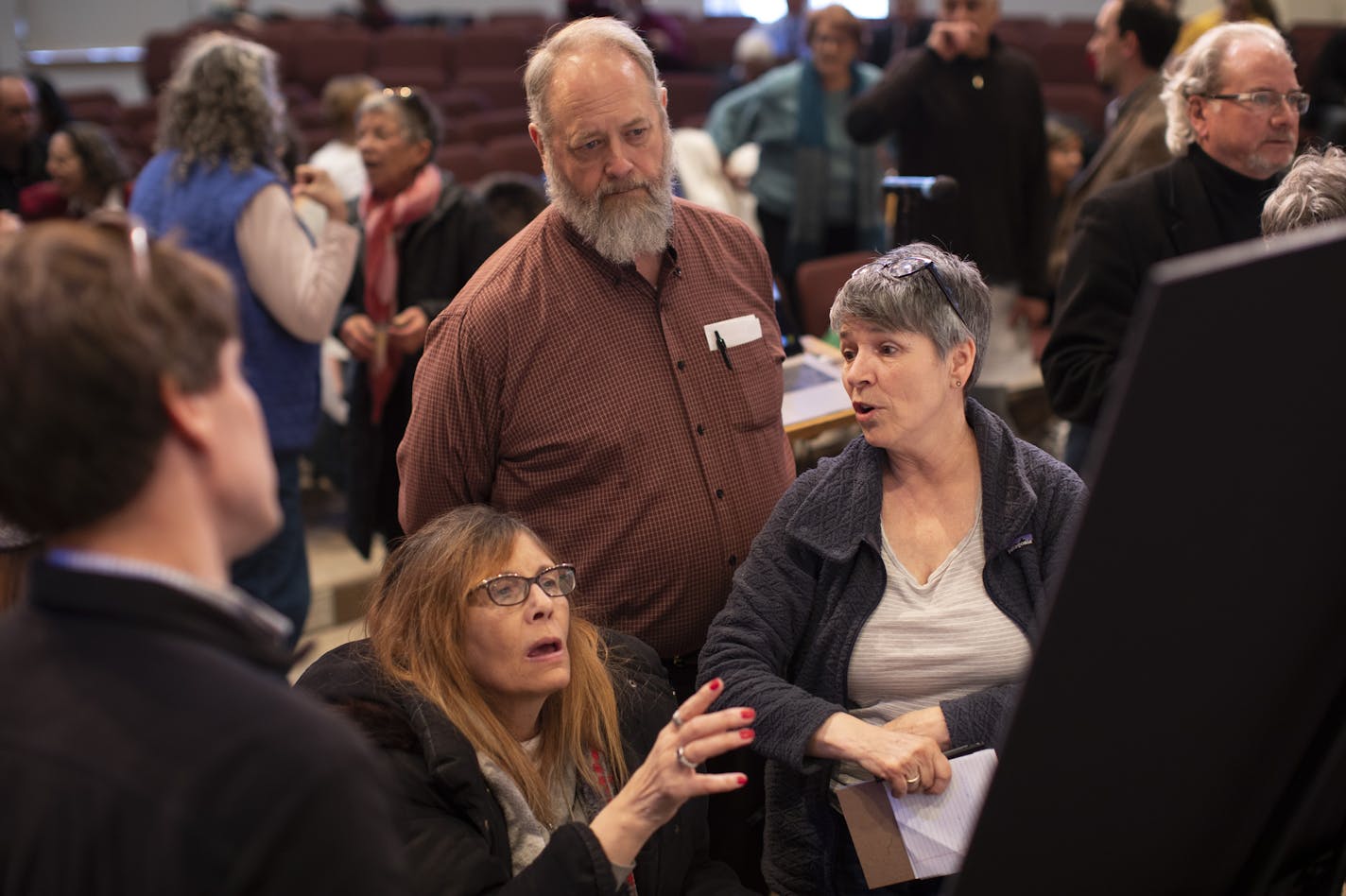 Neighborhood residents, including Marylee Woods, gesturing, and her husband, Larry Woods, standing behind her, discussed the plans on display before the meeting began. ] JEFF WHEELER &#xef; jeff.wheeler@startribune.com A community forum was held at Minnehaha Academy Wednesday night, April 4, 2018 to discuss the design plans to rebuild the school.