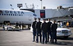 A Minnesota National Guard Honor Guard waited to transfer a casket with the remains of John P. Sersha from a Delta passenger jet to a hearse Tuesday d