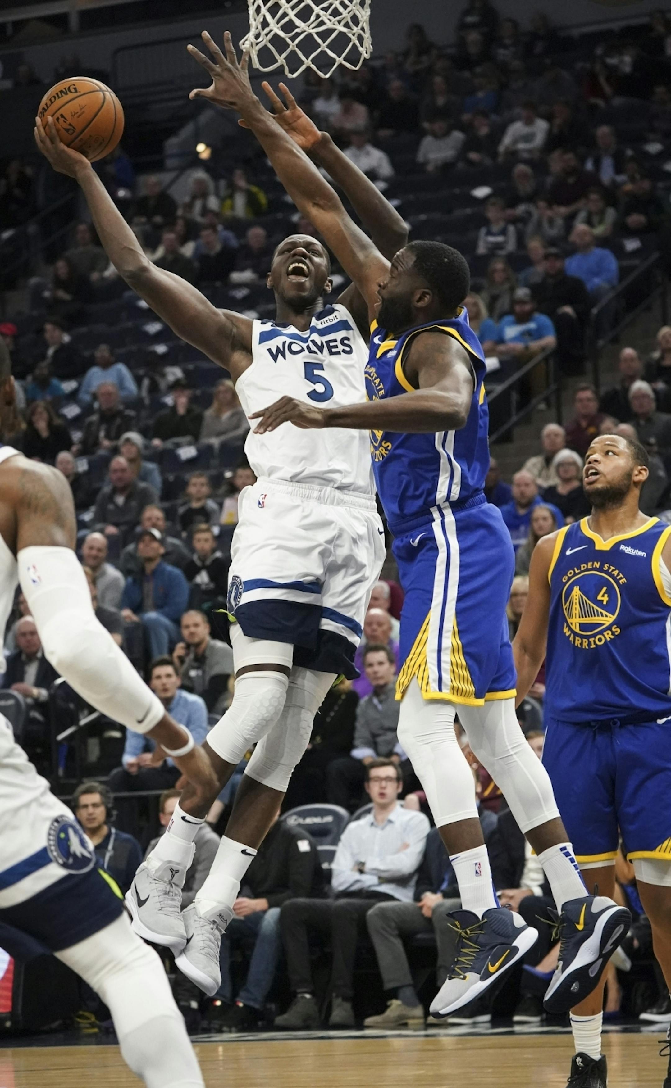 Minnesota Timberwolves center Gorgui Dieng (5) jumped for a shot against Golden State Warriors forward Draymond Green (23) in the first half.