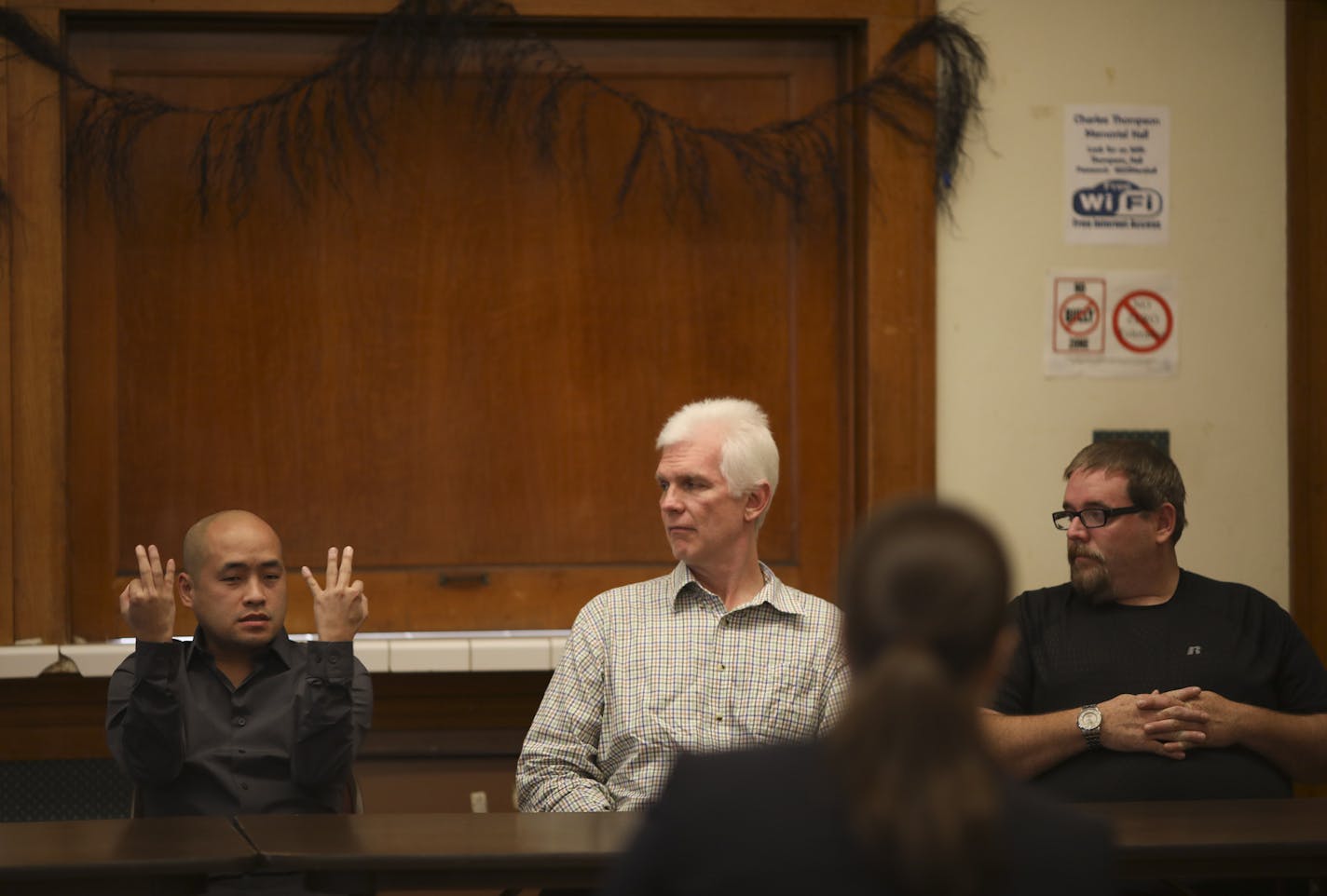 One of the former inmates who was a part of the settlement, Choua Vang, explaned his experience (through American Sign Language) in the Washington County jail as two other former inmates, Alan Read and Nicholas Zentic, right, listened. ] JEFF WHEELER &#xef; jeff.wheeler@startribune.com A settlement has been reached in the cases of several deaf inmates who said they were treated poorly in four county jails. They weren't provided with interpreters, and didn't provide them access to phones or equal