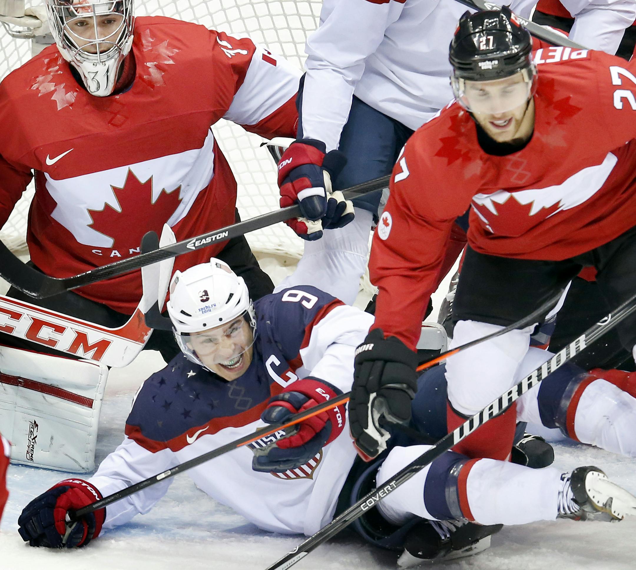 Team USA captain Zach Parise (9) was knocked to the ice in the first period. Canada beat USA 1-0. ] CARLOS GONZALEZ cgonzalez@startribune.com - February 21, 2013, Sochi, Russia, Sochi 2014 Winter Olympics, Bolshoy Ice Dome, men's hockey semifinal, USA vs. Canada