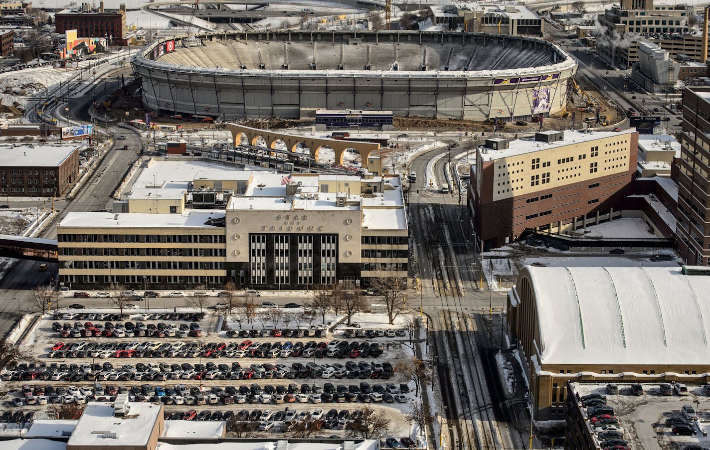 In February 2014, the Star Tribune building was still standing near the shell of the old Metrodome and a surface parking lot filled part of the Commons' eventual footprint.