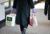 A rubber gloved shopper carried paper towels and other supplies through the downtown Minneapolis skyway.