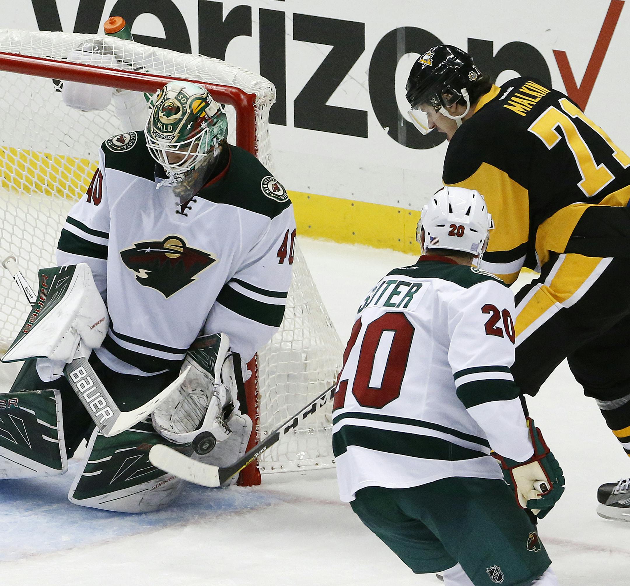 Minnesota Wild goalie Devan Dubnyk (40) stops a shot by Pittsburgh Penguins' Evgeni Malkin (71) during the third period of an NHL hockey game in Pittsburgh, Thursday, Nov. 10, 2016. The Wild won 4-2. (AP Photo/Gene J. Puskar)